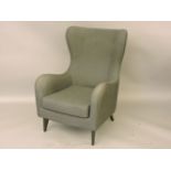 A modern retro design armchair, in charcoal upholstery, with ebonised legs