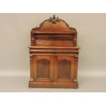 A Victorian mahogany chiffonier, carved raised back over drawers and cupboard doors, 107cm wide