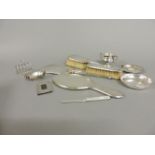 An assortment of silver, comprising a three piece engine turned dressing table set, Birmingham 1930,