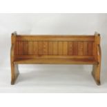 A Victorian pitch pine pew, 152cm wide, 87cm high