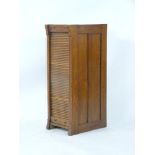 An early 20th century tambour front filing cabinet