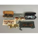 A collection of vintage sunglasses, including Pablo Picasso and Paola Belle