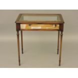 A reproduction mahogany table cabinet, on turned legs, containing a display with a pipe mould, two