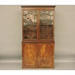 A 19th century bookcase cabinet, the upper section with astragal glazed doors, further doors to each