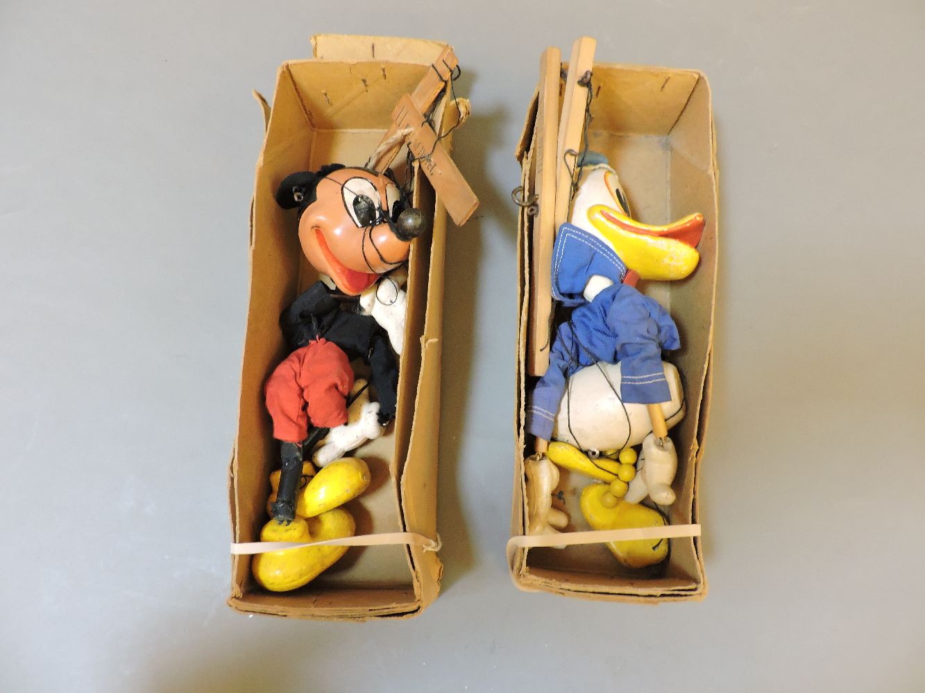 Two Pelham Puppets, Mickey Mouse and Donald Duck, in brown boxes