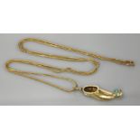 A gold shoe pendant, tested as approximately 14ct gold, set with turquoise coloured stones on a