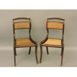 A pair of Regency period side chairs, with bergère seats and backs, on sabre legs