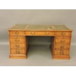 A reproduction yew wood twin pedestal desk