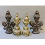 A pair of 19th century carved oak fleur de lys finials, 33cm, and a pair of brass chenets, 31cm