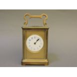 A French brass carriage clock, striking on a gong, back plate stamped 'R & Co, Made in Paris',