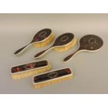 A tortoiseshell and silver five piece dressing set