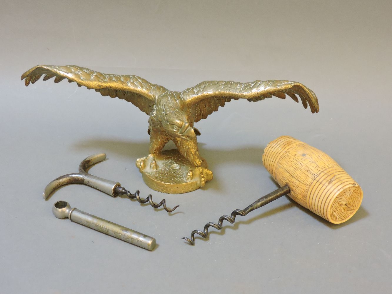 A Desmo accessory car mascot, in the form of an eagle, together with corkscrews