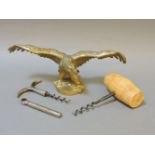 A Desmo accessory car mascot, in the form of an eagle, together with corkscrews