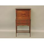 An Edwardian inlaid mahogany music cabinet, with cupboard door over two drawers, 56cm wide, 107cm