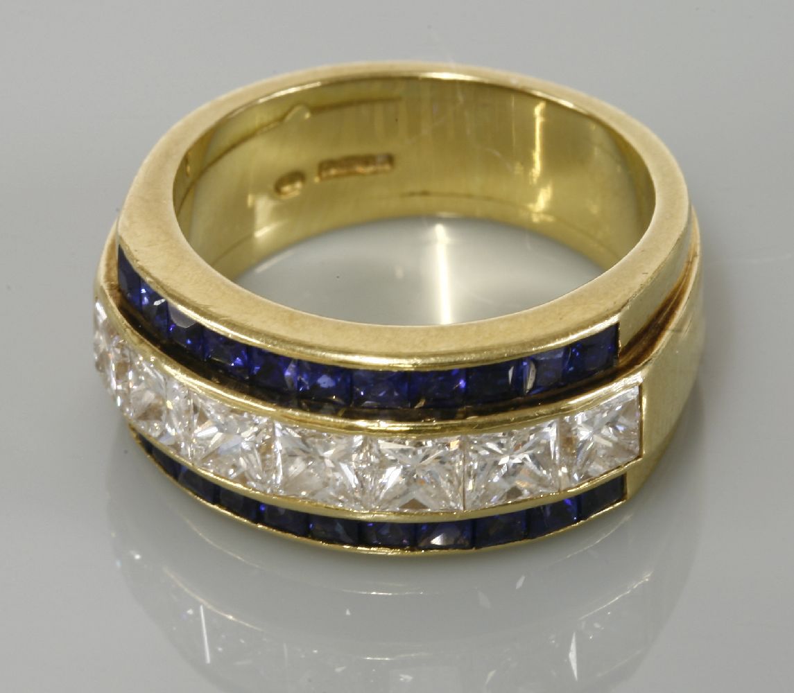 An 18ct gold diamond and sapphire half hoop ring, with a central row of princess cut diamonds,