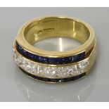 An 18ct gold diamond and sapphire half hoop ring, with a central row of princess cut diamonds,