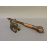 A Victorian olivewood letter opener, with carved sea monster finial, 36.5cm long, and a Black Forest