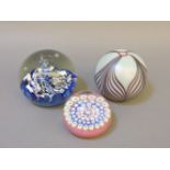 Three 20th century paperweights, including a Caithness C11G, a John Deacon, and another