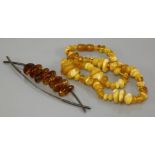 A single row graduated free form amber bead necklace, of varying shades, together with a