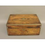 A Victorian rosewood toiletry box, the fitted interior with silver plated mounted bottles, and a