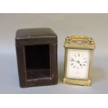 A brass carriage clock, by Dent, in original leather case, clock 16cm high