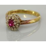 A ruby and diamond oval cluster ring, marked 18ct