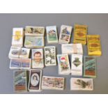 A collection of various complete sets of cigarette cards, to include fish, cards, ships' badges,