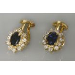 A pair of 18ct gold sapphire and diamond oval cluster clip on earrings, easily converted to