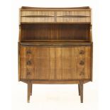 A Danish rosewood bureau,the top fitted with four drawers over a shelf, lacking glass fronts, the