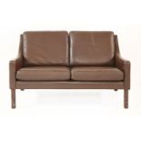 A Danish leather two-seater settee,with dark brown upholstery,122cm wide
