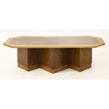 An Art Deco walnut and sycamore coffee table,with canted corners, raised on a plinth stand,127.5cm