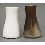 Two porcelain jugs,by Joanna Constantinidis (1927-2000), one clear white, the other with a two-