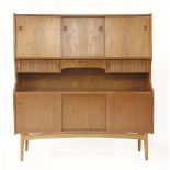 A Danish high-backed sideboard,with three sliding cupboards over a central drawer and tambour