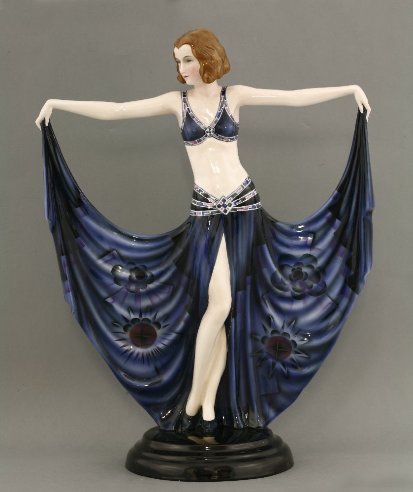 A Goldscheider figure of a dancer,model no. 6173, modelled holding her dress, in blue with