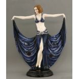 A Goldscheider figure of a dancer,model no. 6173, modelled holding her dress, in blue with