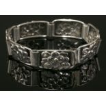 A Danish silver bracelet,by C Brumberg Hansen, with a series of pierced floral plaques to
