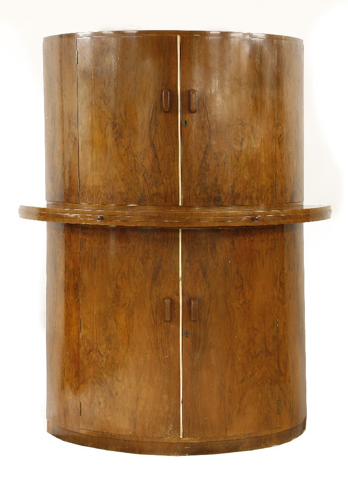 An Art Deco walnut two-part cocktail cabinet,opening to reveal a birch interior, labelled 'G & F