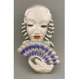 A Goldscheider pottery wall mask,model no. 6542, in an unusual colourway with silver hair and