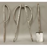 A three-piece fire set,after a design by Charles Rennie Mackintosh for Hill House,tongs 33cm long