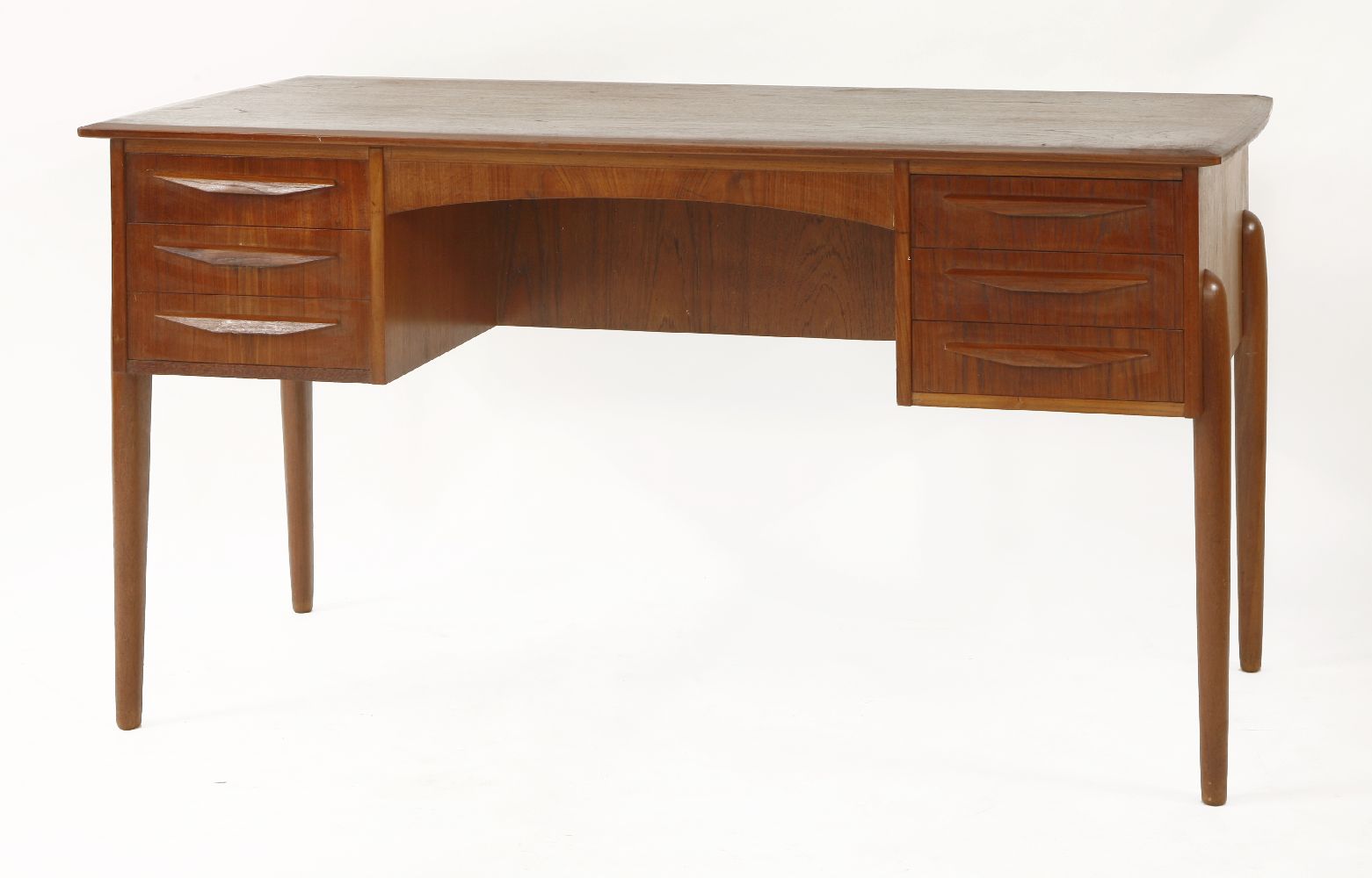 A Danish teak desk,with a chamfered top and three drawers either side, the reverse with a long