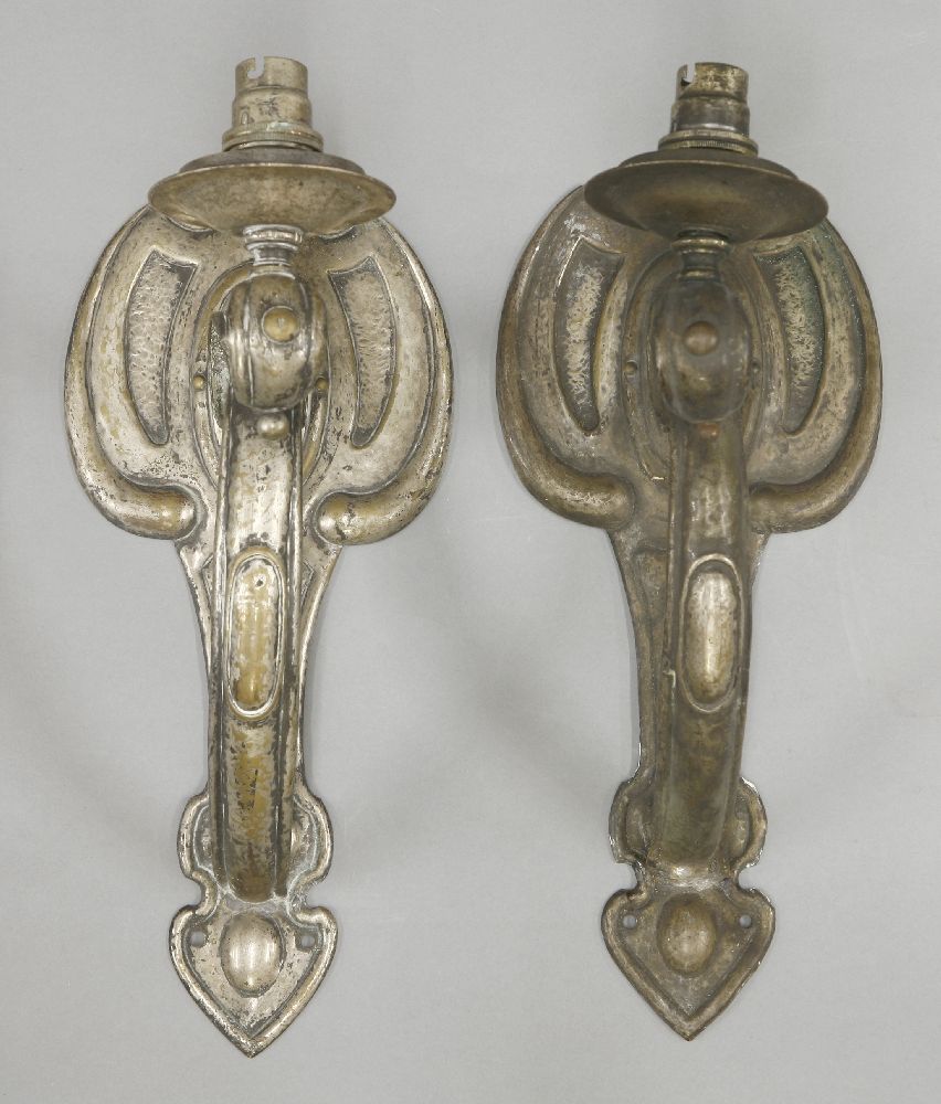 A pair of silver-plated brass wall lights,each with a single light on a scrolled arm,32.5cm high (