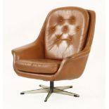 A Danish swivel lounge armchair,in tan leather