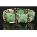 A gold mounted jade plaque link bracelet, c.1950,with a series of shallow square jade pyramid
