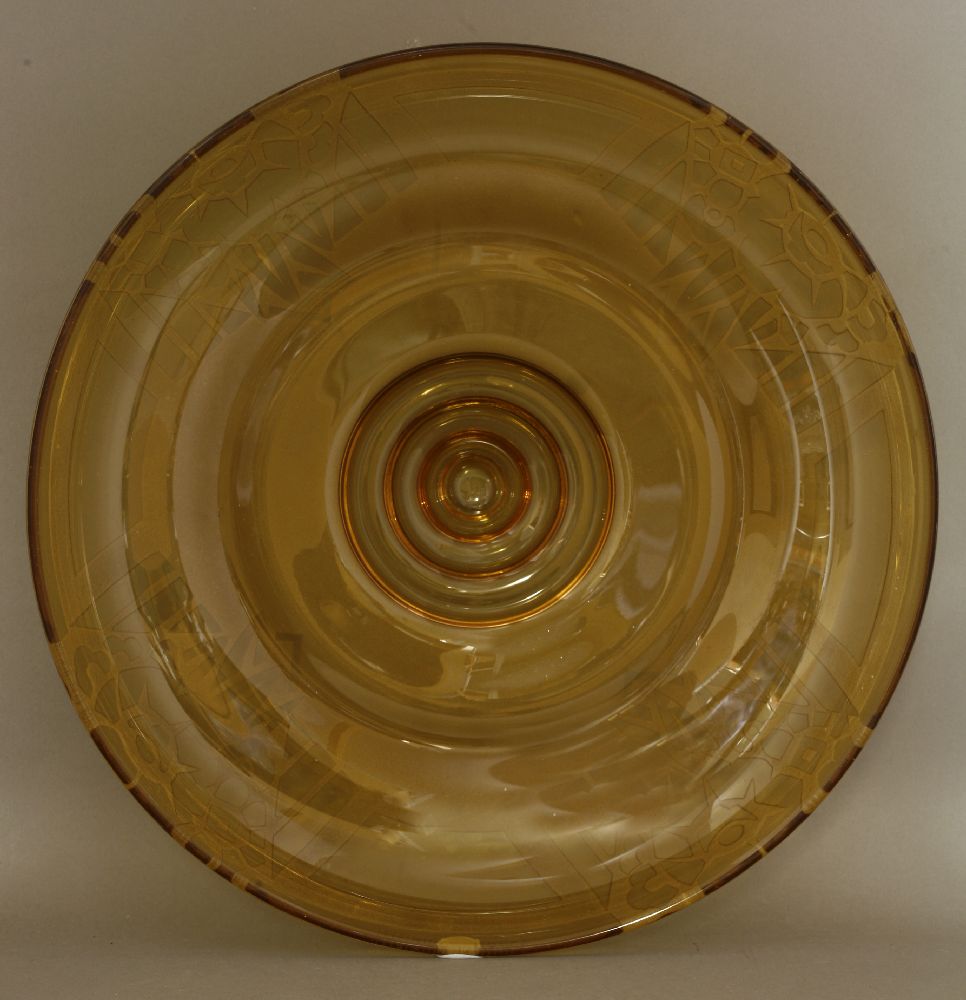 An amber glass dish,deeply engraved and etched with stylised floral designs, engraved 'H Delatte,