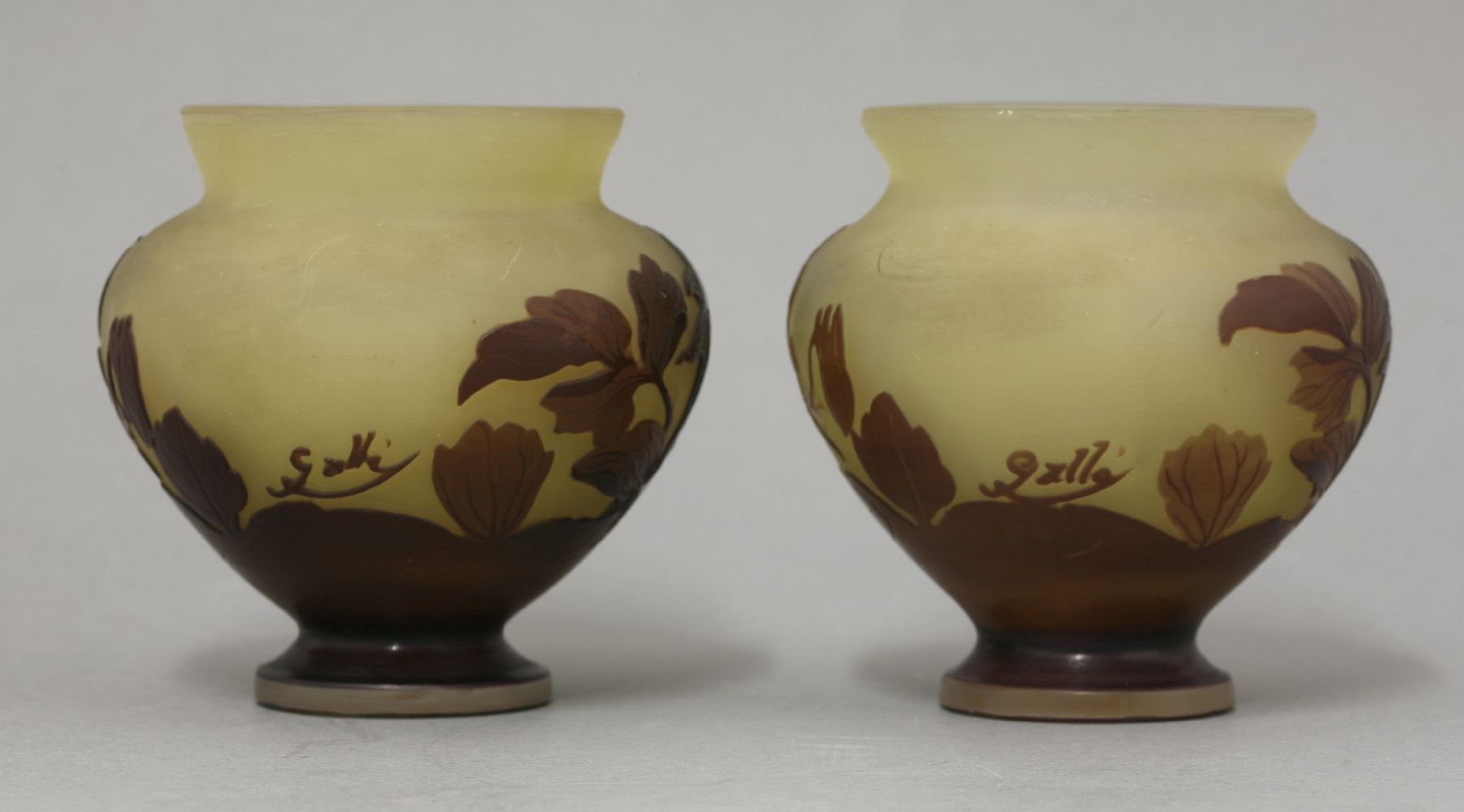 A pair of Gallé cameo glass vases,in amber and polished purple glass in the form of flowers, - Image 2 of 3