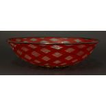 An Italian Murano clear glass bowl,with red latticed inclusions, the black rim with aventurine