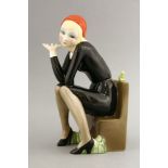 A Lenci figure,'Nella', modelled by Helen Koenig Scavini, modelled as a girl seated on a bench