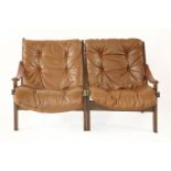A pair of bentwood loungers,each with tan leather seats and backs (2)
