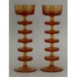 A pair of Wedgwood topaz glass Sheringham candlesticks,designed by Ronald Stennett-Wilson, pattern
