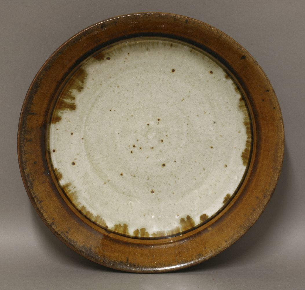 *A stoneware dish,by Richard Batterham (b.1936), with a brown-glazed rim and a light celadon centre, - Image 2 of 2